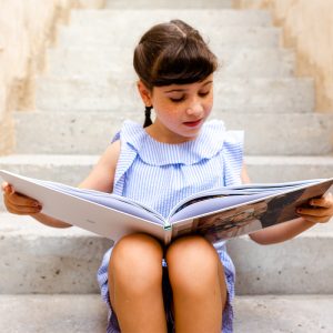 girl looking at photo album