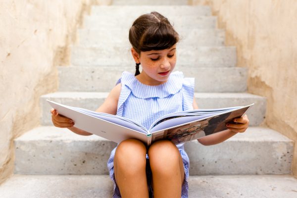 girl looking at photo album